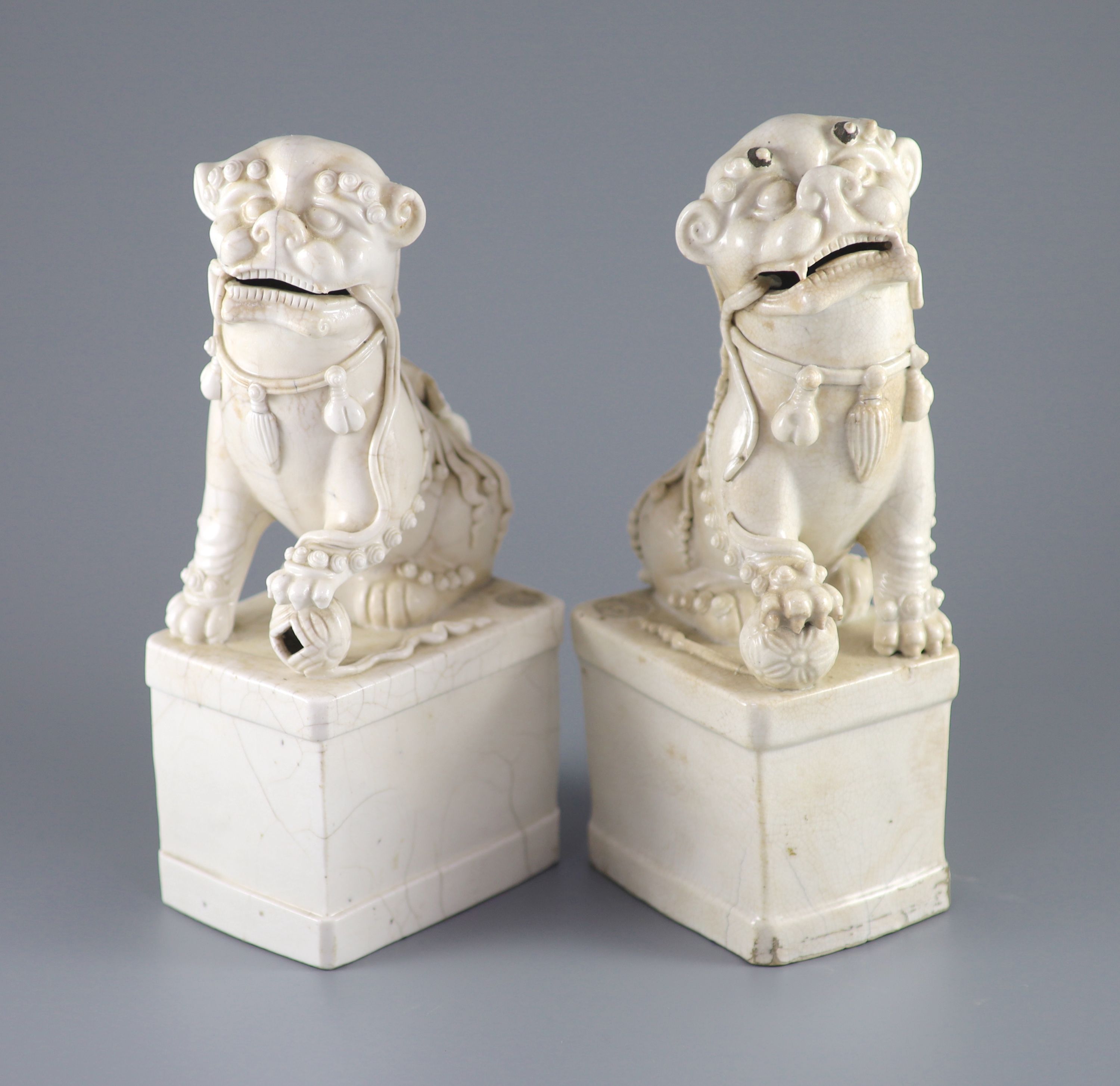 A pair of Chinese Dehua Blanc de chine kylin joss stick holders, some cracks. 26cms